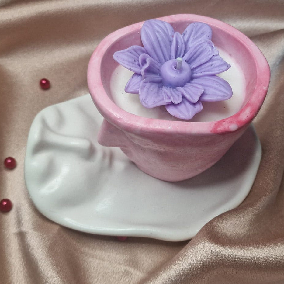 Pink silicone cup with purple flower on a beige fabric background