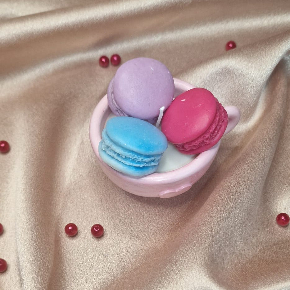 Colorful macaron-shaped containers on a beige fabric background