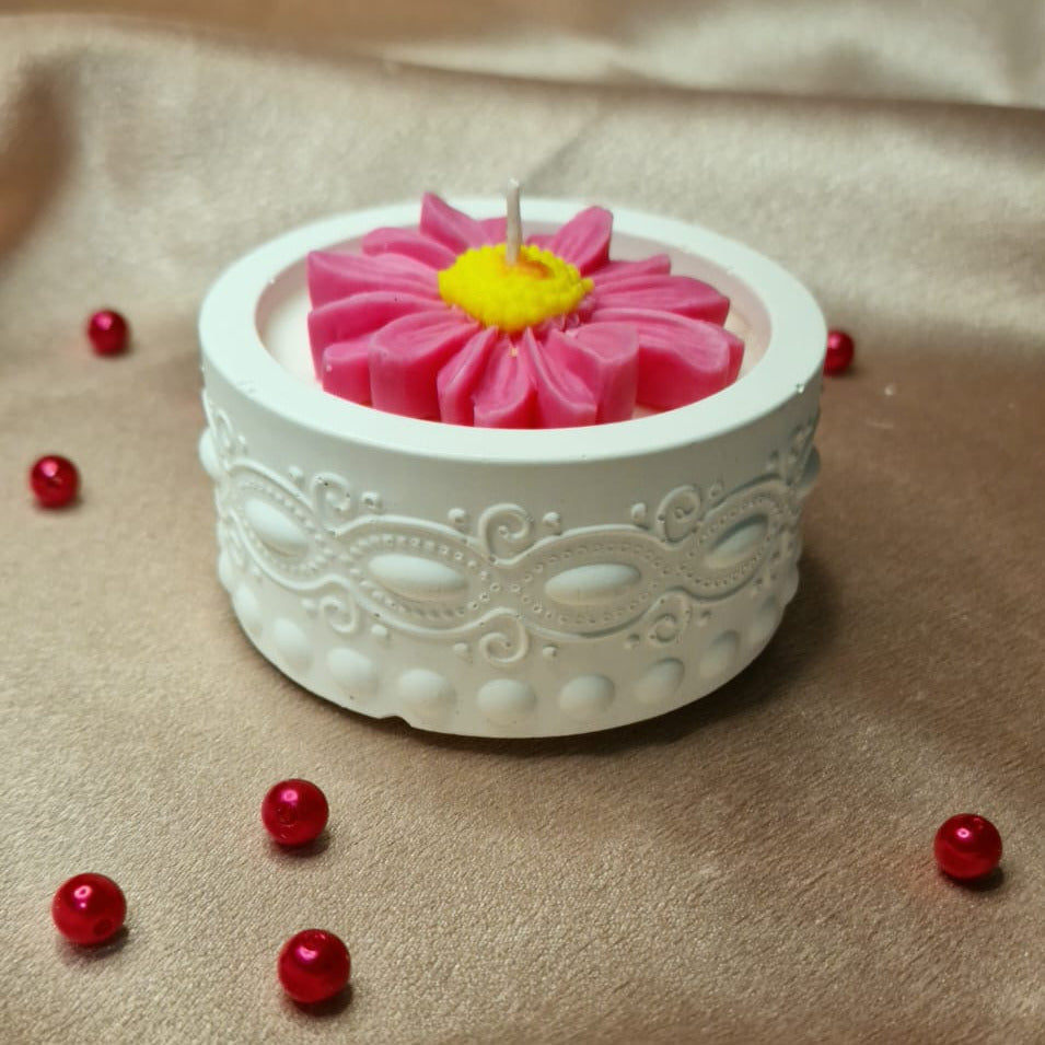 Decorative pink flower in a white container on a beige fabric background