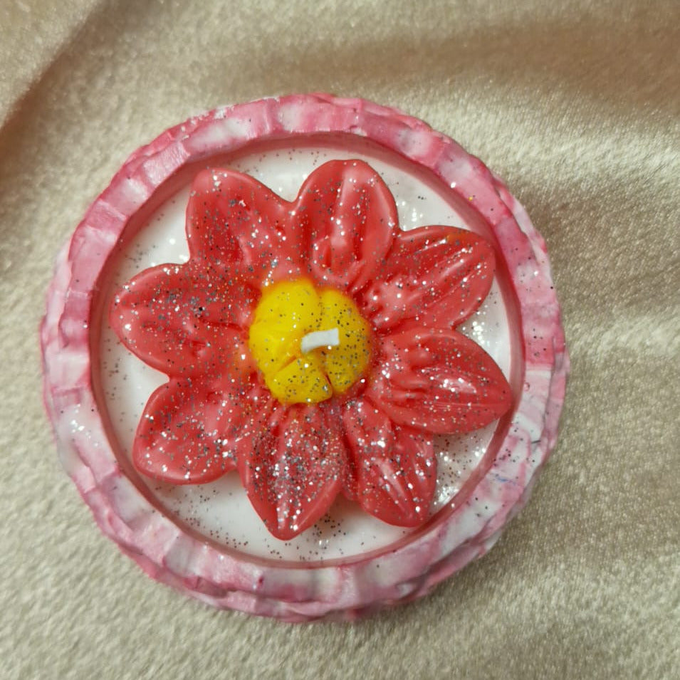 Floral design with red petals and yellow center on a beige fabric background