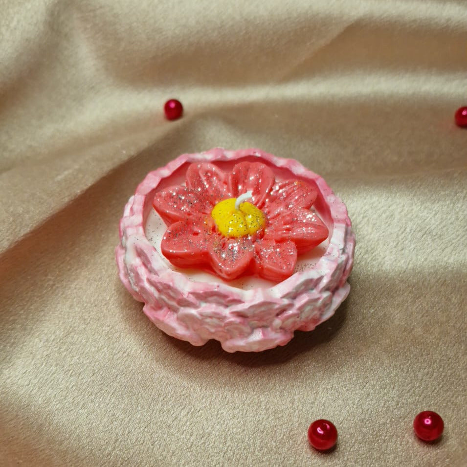 Pink flower-shaped object with a yellow center on a beige fabric background