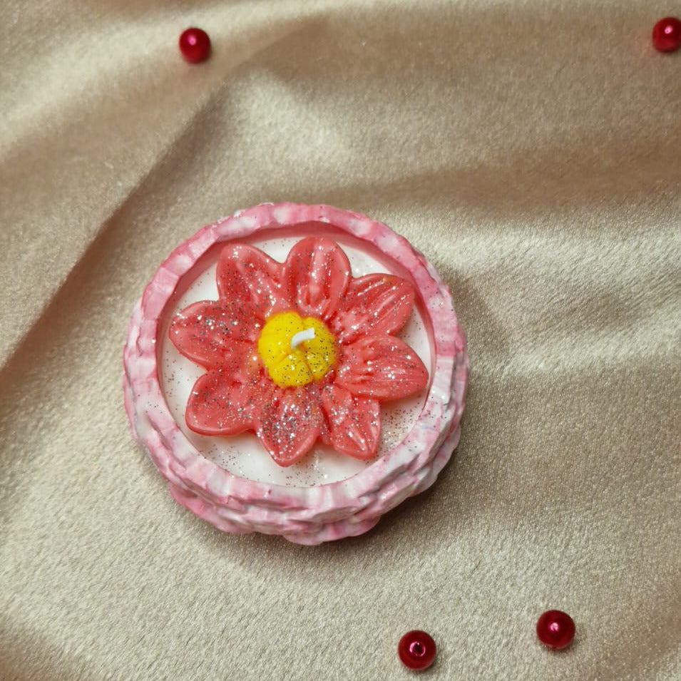 Pink flower-shaped object with a yellow center on a beige fabric background